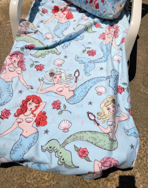 Cute beach towel featuring vintage inspired mermaids in beautiful pastel colors by Miss Fluff.
